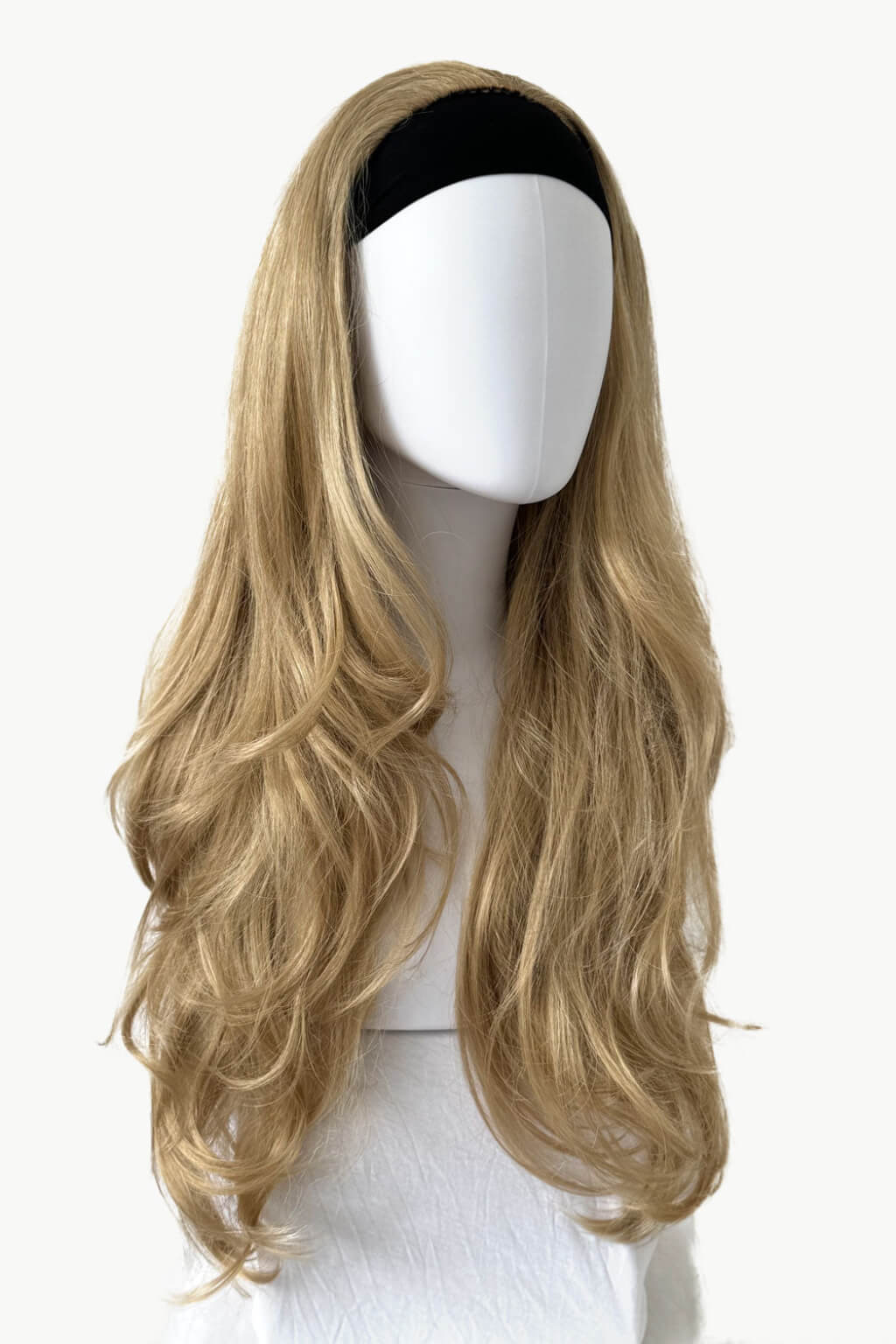 A long, wavy blonde wig with a black headband, displayed on a white mannequin head against a plain white background. Blonde half wig hairpiece (3/4 wig), loose curls: Suki blonde 24H613