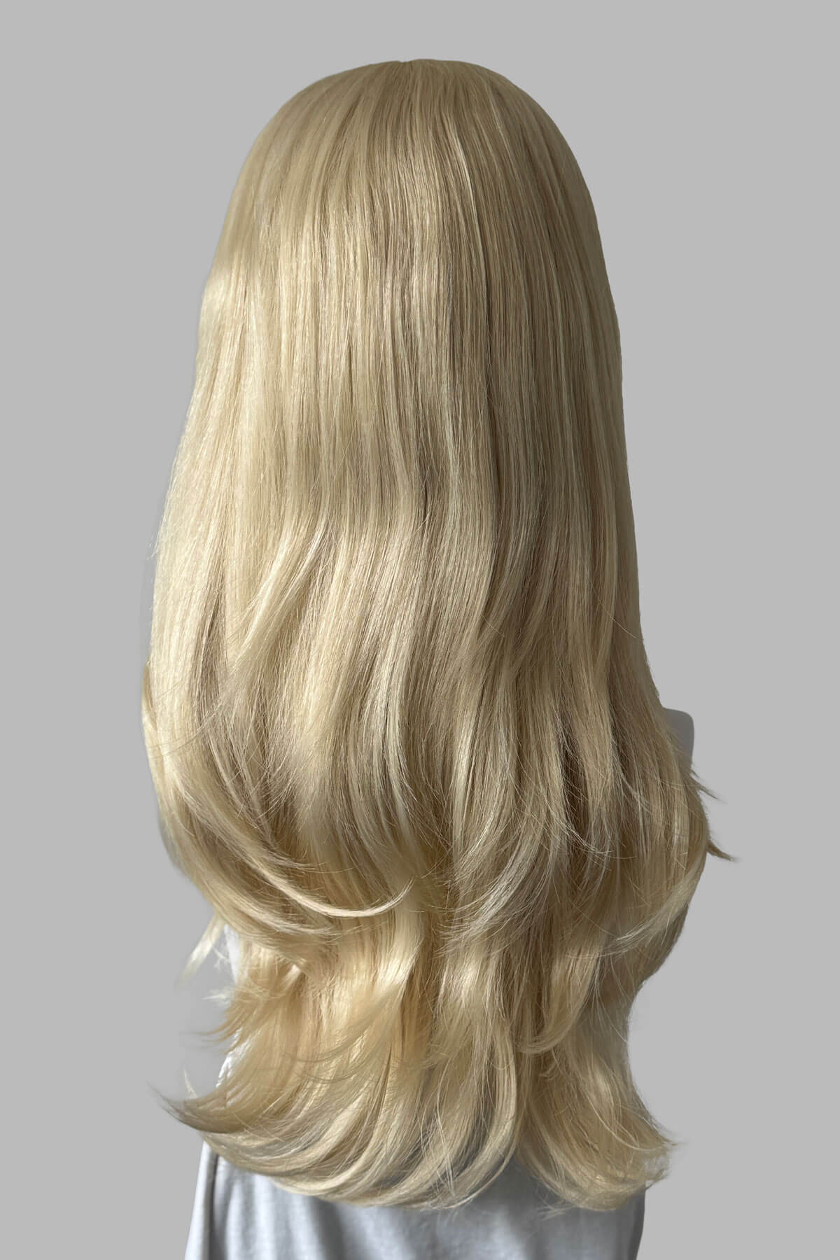 A long wavy light blonde half wig, displayed on a mannequin against a light grey background. Claudia - Volume Boosting Long Gentle Bouncy Layered Half wig light blonde 613