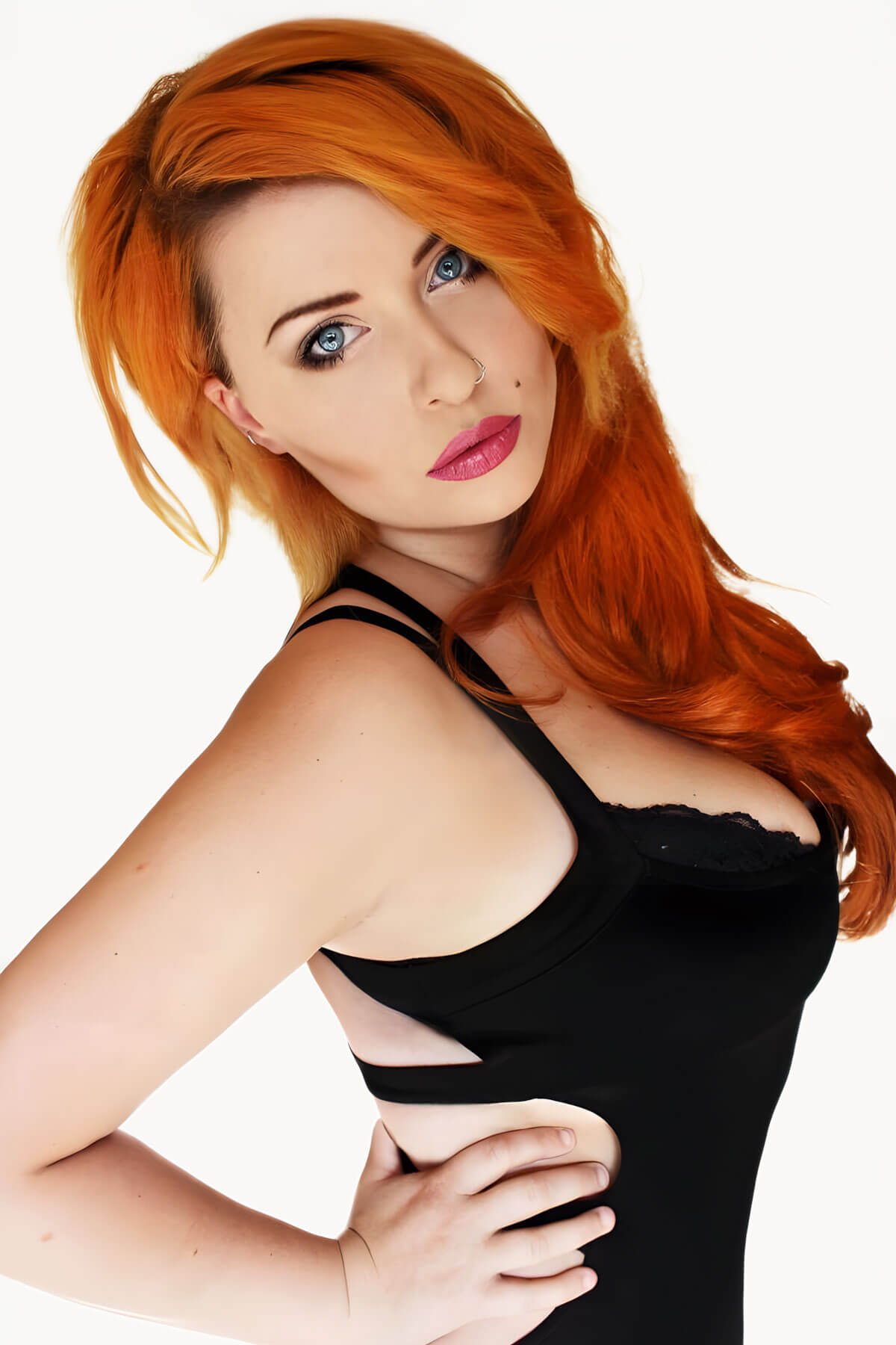 Woman with red hair wearing a black top on a white background. Wavy ginger half wig hairpiece extension (3/4 wig): Eris