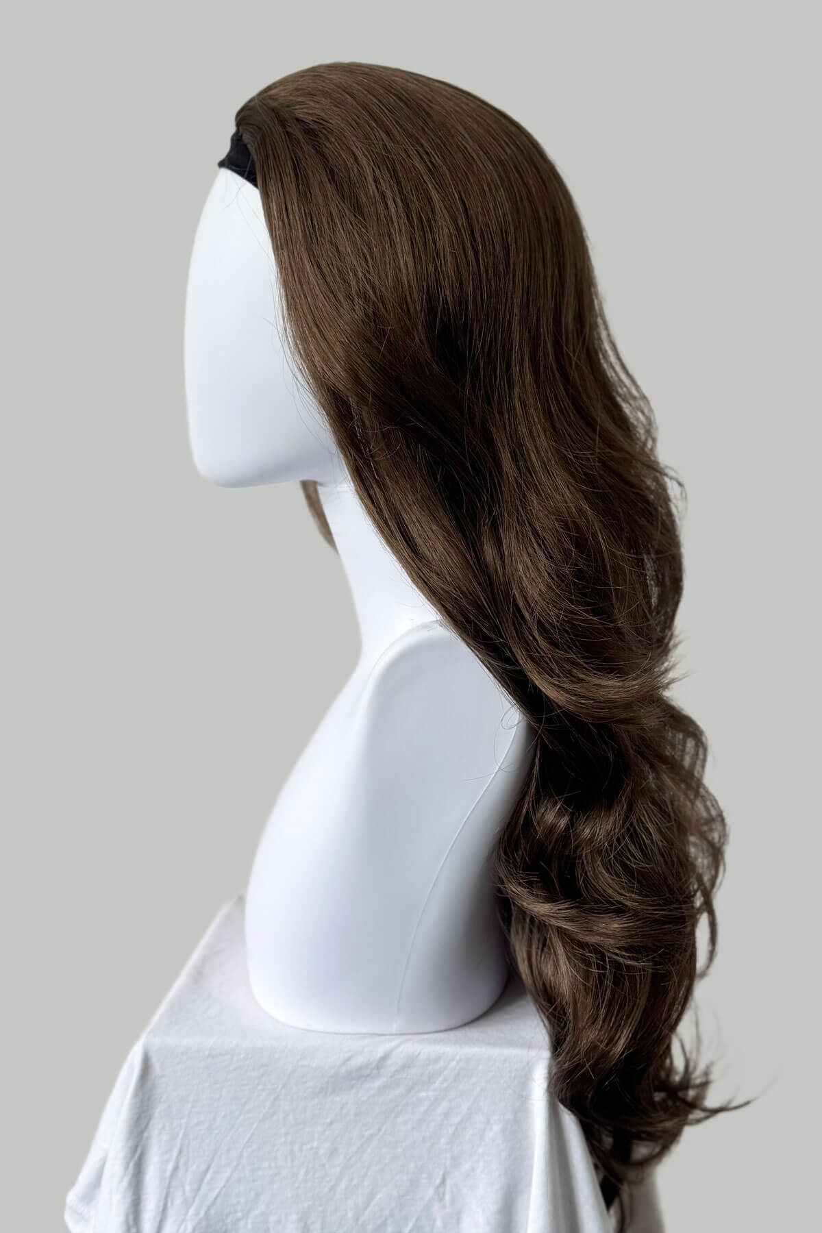 Long, wavy brown hair on a plain background. Brown half wig hairpiece, full, long with gentle waves: Taya mocha brown 10