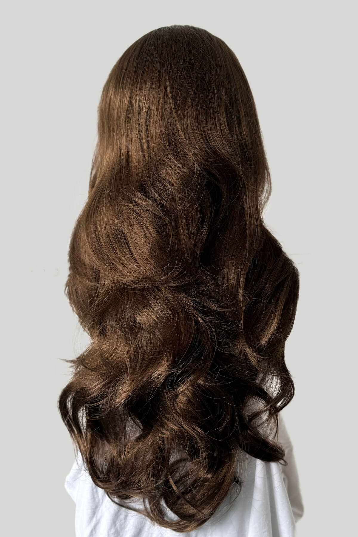 Long, wavy brown hair on a plain background. Brown half wig hairpiece, full, long with gentle waves: Taya mocha brown 10