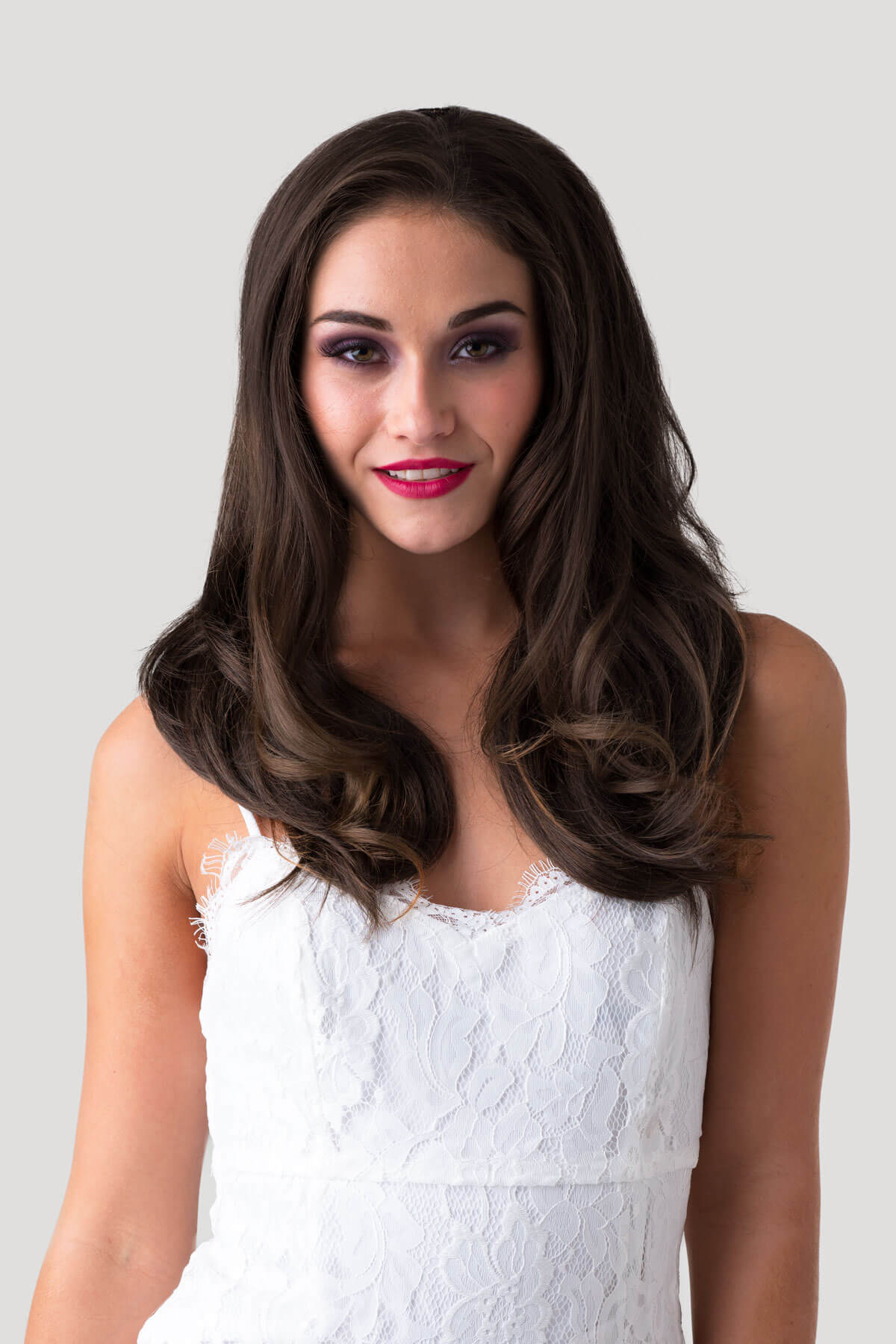 Woman wearing a white lace dress against a plain background. Brown half wig hairpiece (3/4 wig), gently layered: Briar chestnut brown 8