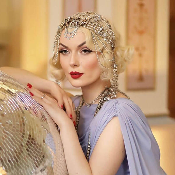 Women with beautiful blonde wavy hair posing in 1920s film star style.