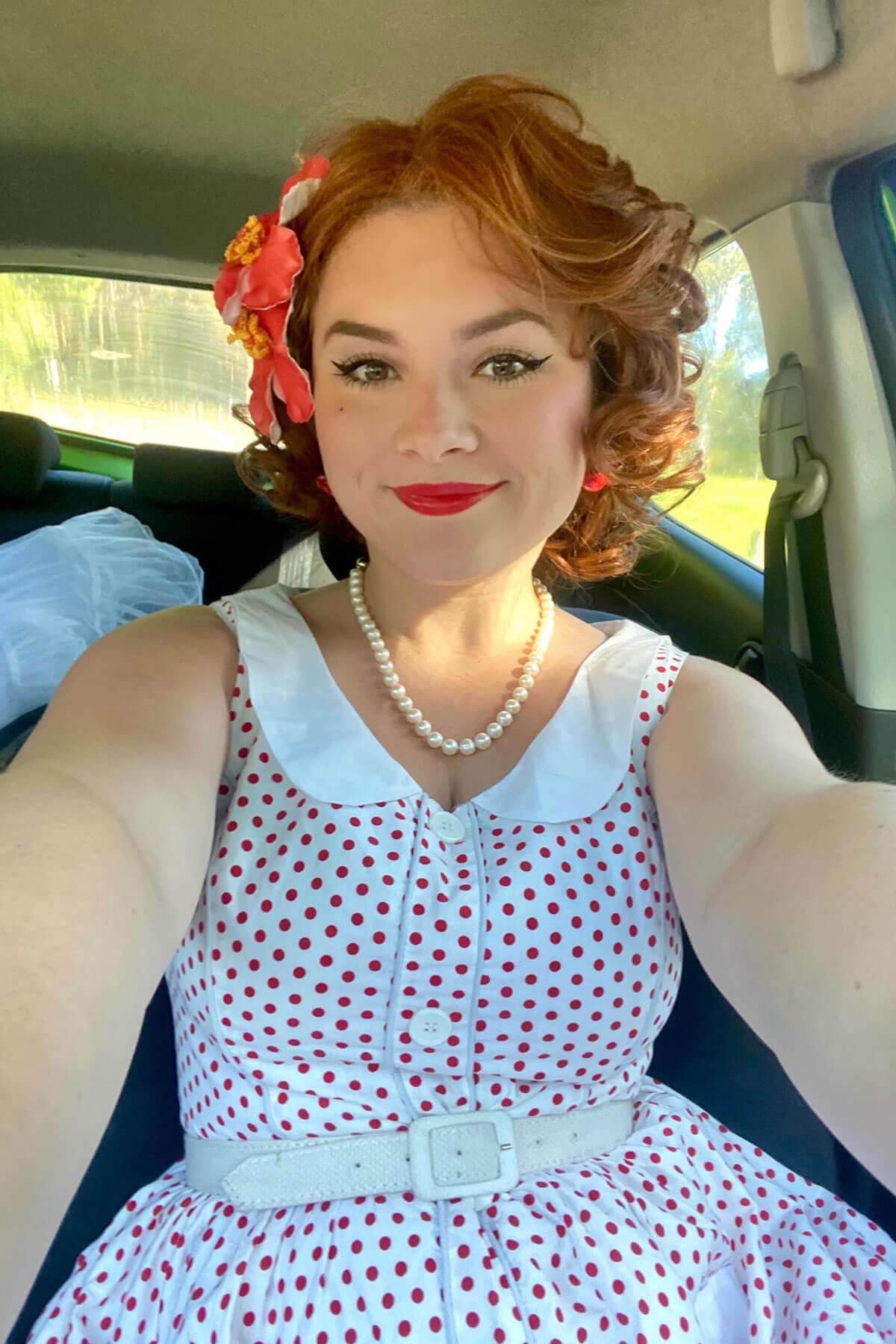 Women in a car with beautiful auburn hair. Auburn pinup wig, lace front, vintage style: Clementine