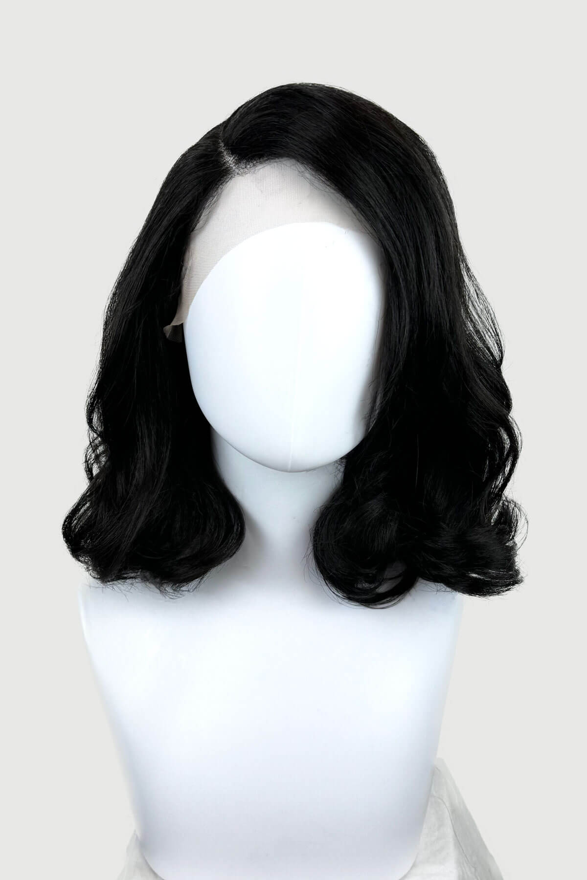 Black lacefront wig with side partingon a mannequin. Black shoulder length long bob (lob) lacefront wig with side sweeping fringe/bangs: Amaris