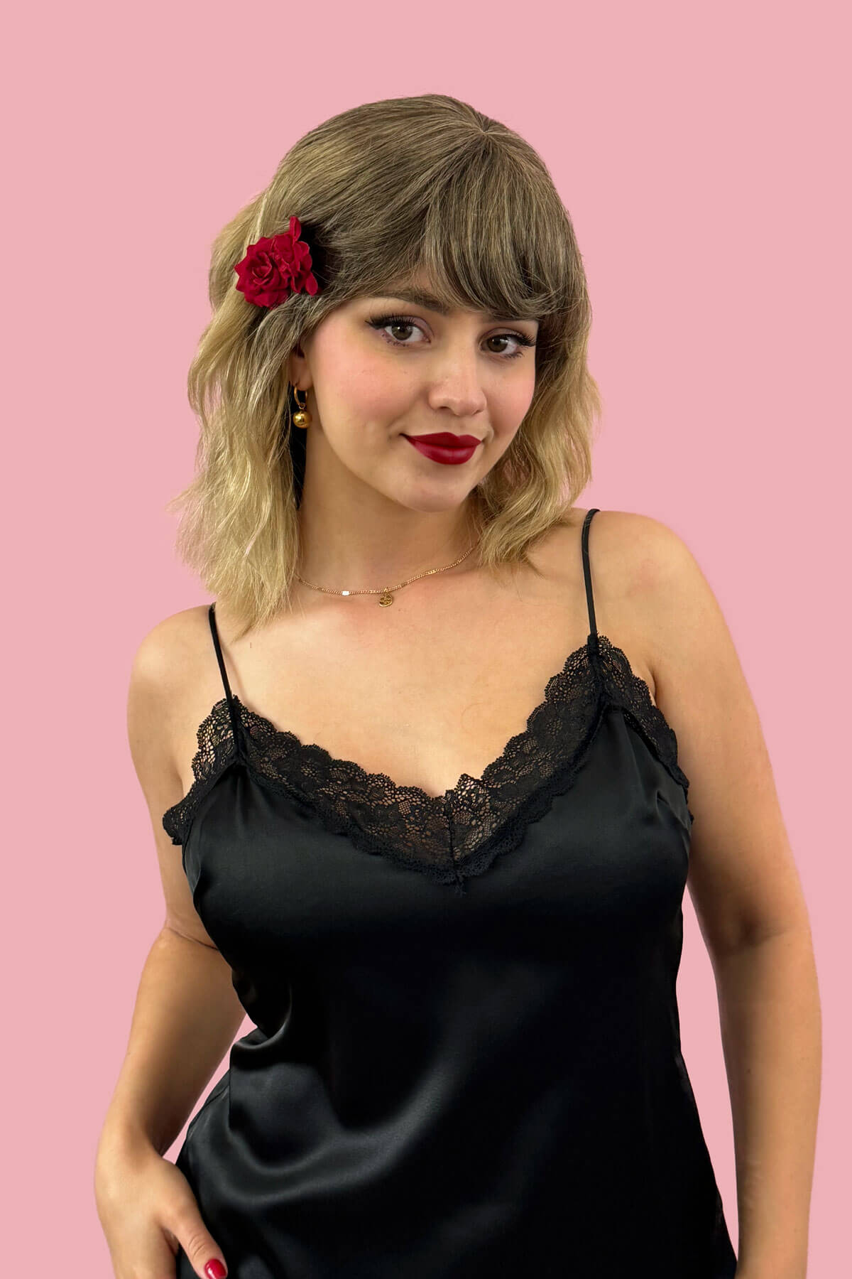 Woman wearing a black top against a pink background. Long dark brown bob wig (LOB) with textured waves: Anais 8TN24