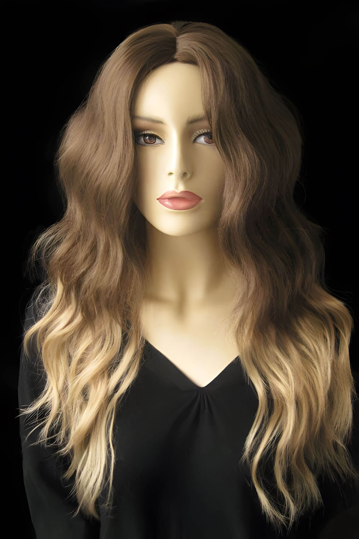 Mannequin head with long wavy brown and blonde wig on a black background. Dip dye chocolate brown and honey blonde wig long wavy wig with no fringe: Genevieve