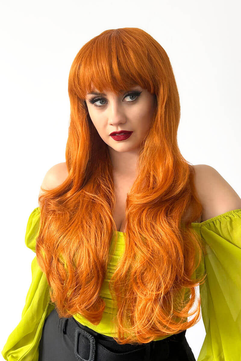 Long wavy ginger wig with vintage-style straight fringe: Coral